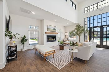 A modern living room with a fireplace and a large window.